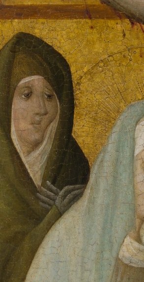 A woman in a green hood watches.