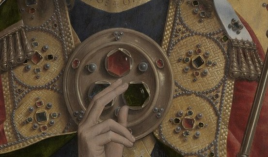 His golden robe glows with intricate embroidery.