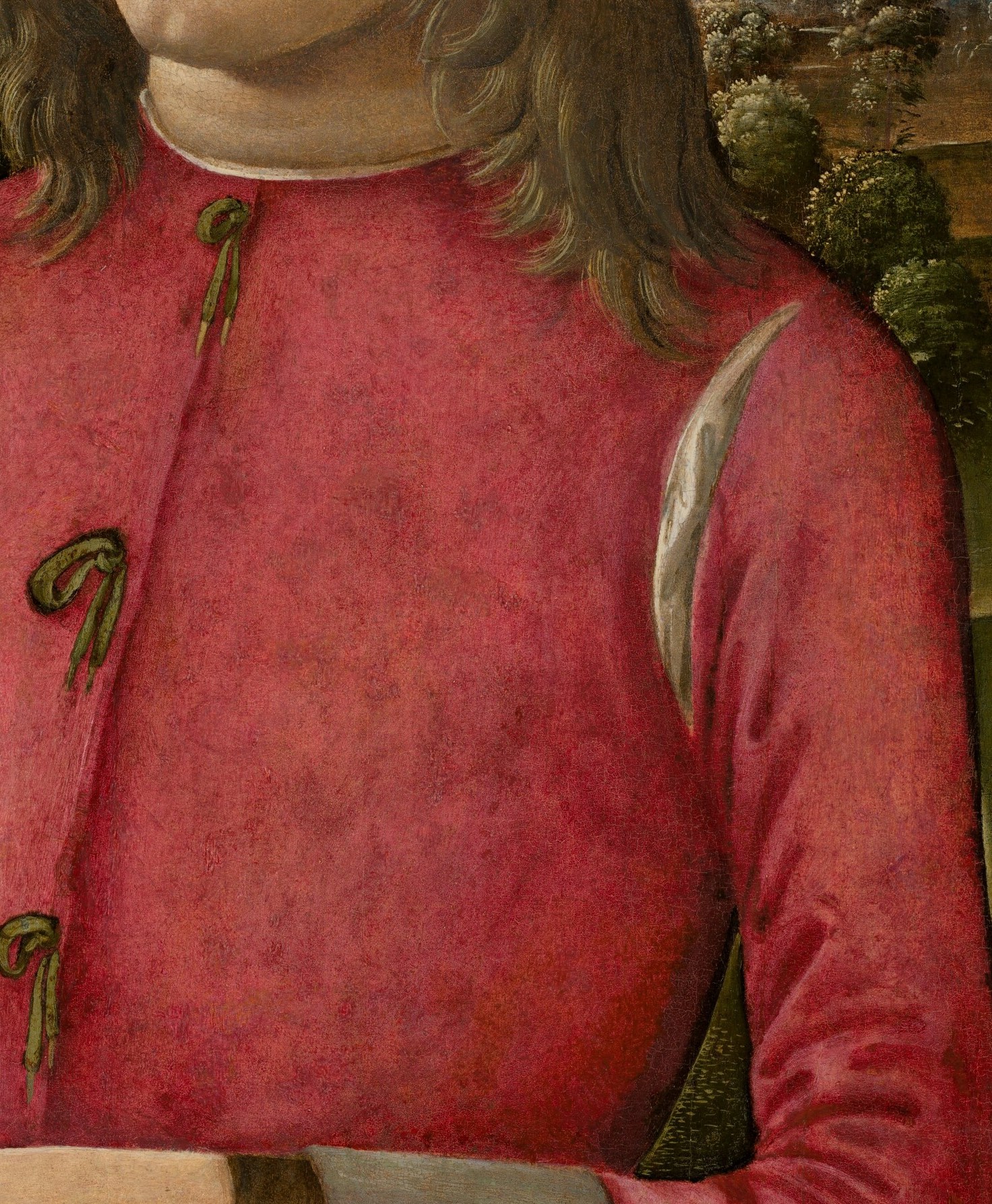 The rich red fabric and subtle folds suggest wealth and status.