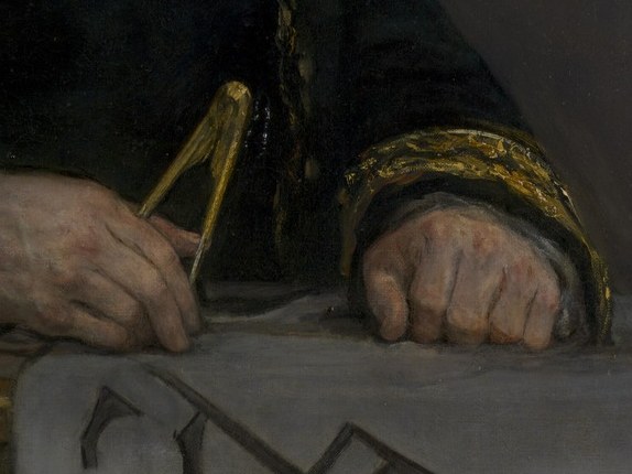 His hands are actively engaged with the tools of his trade, showing his dedication.