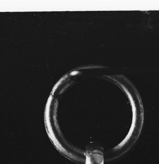 That ring at the top is how it hung from a chain, against the skin.