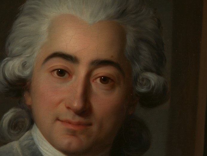 His wig is powdered and piled high.