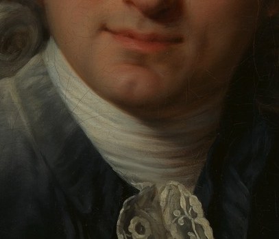 The lace on his collar is very fine.