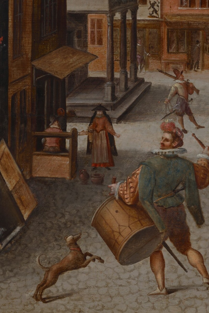 A man sweeps the cobblestones.