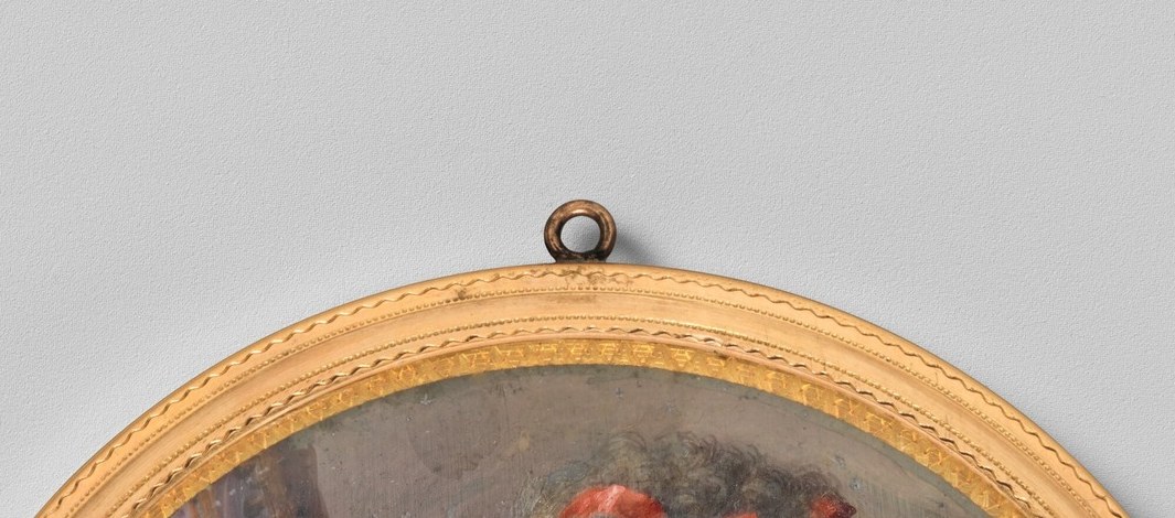 High late-18th-century hairstyle pinned with vivid red-orange flowers or ribbons; places the sitter squarely in 1790s fashion despite a Spanish court date.