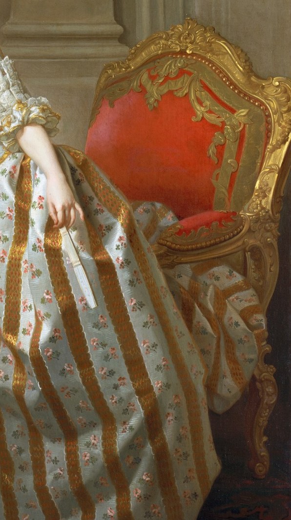 The chair is neither sat in nor pushed aside , standing beside it implies she could sit, i.e., that a throne is hers by right; a compositional argument about status without words.