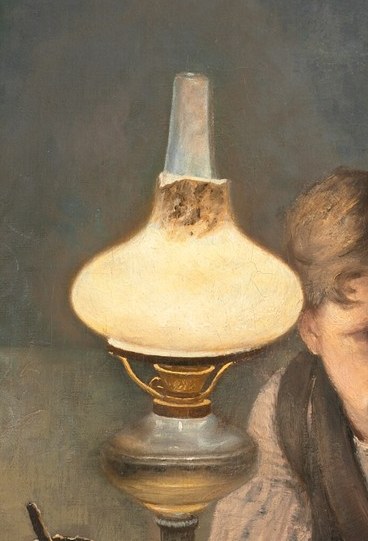 The glowing lamp casts warm light across their faces.