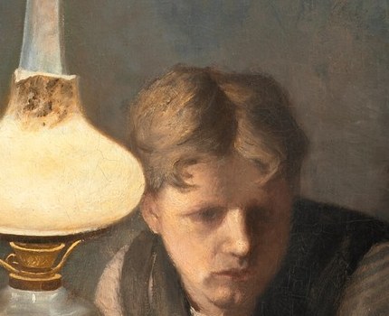 His expression is serious, perhaps a bit weary, and his focus is on the work or the conversation.
