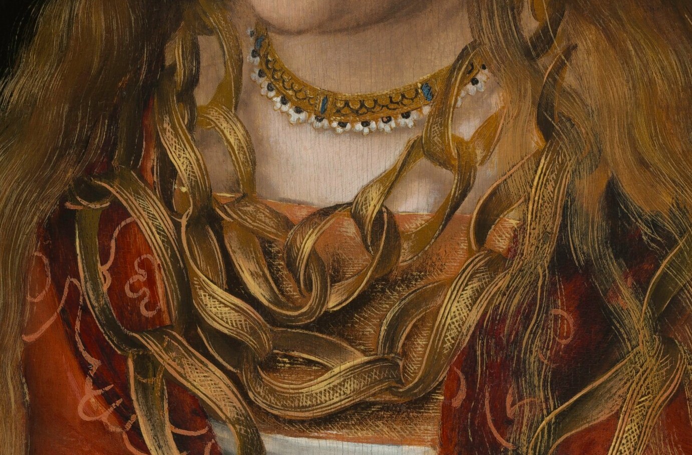 The heavy gold chains are a dynastic weight.