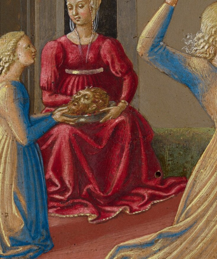 A woman in red, Herodias, holds the gruesome prize.