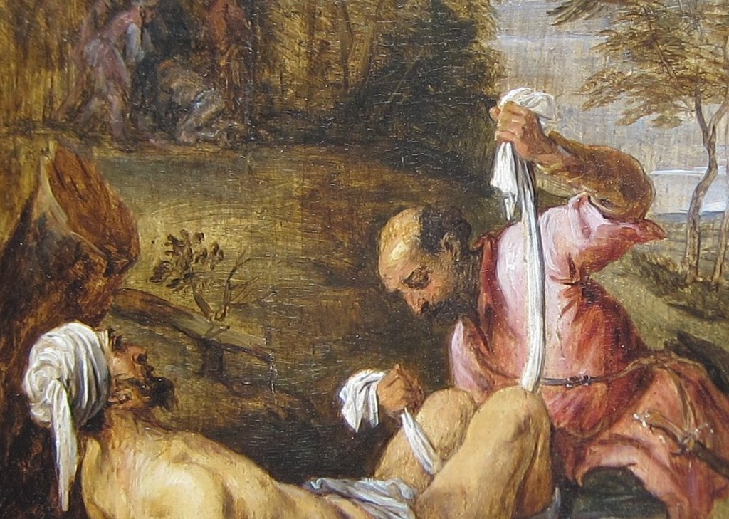 The semi-nudity signals vulnerability; the pale, slack body contrasts with the richly clothed Samaritan, visually encoding the power imbalance reversed by charity.