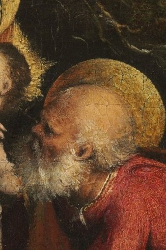 He looks toward the Christ Child.