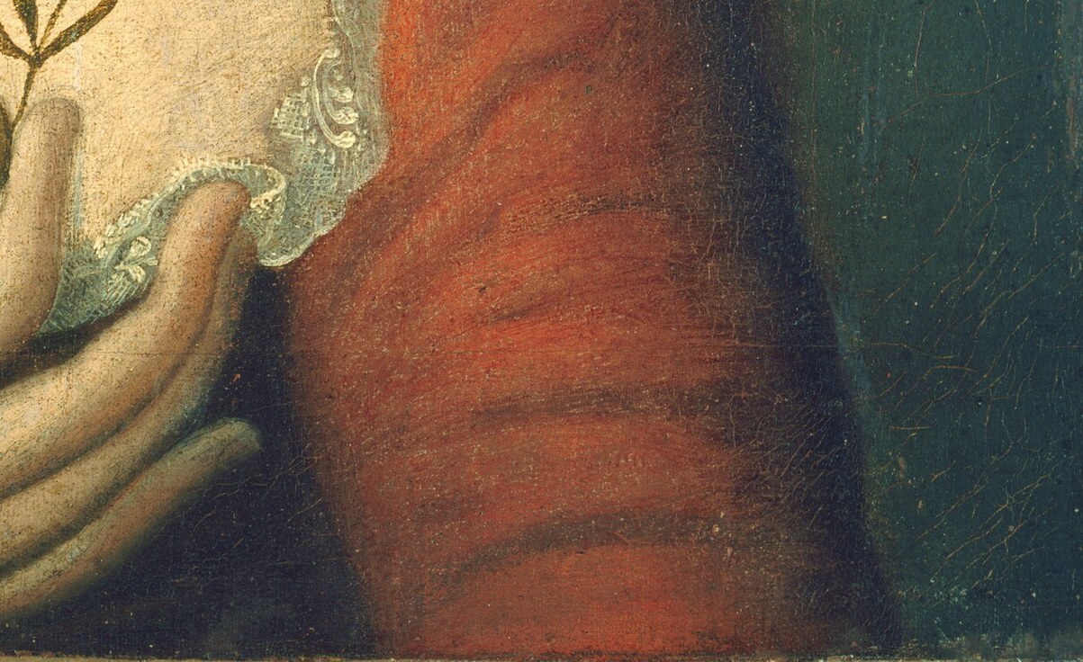 The vibrant red fabric and its texture suggest wealth and status.