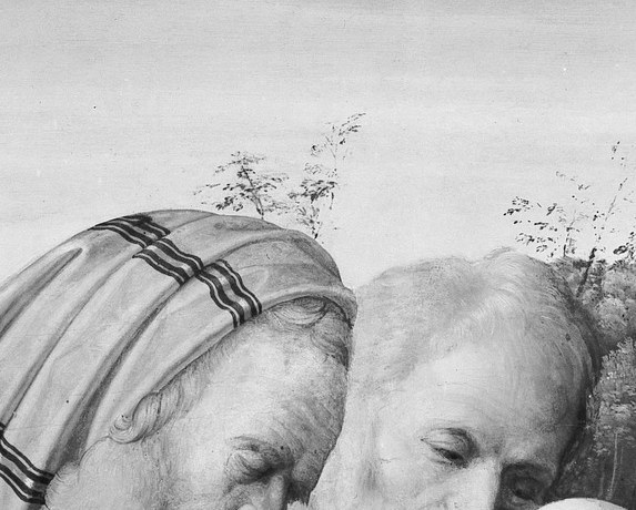 The elder priest bows over the infant, blade in hand.