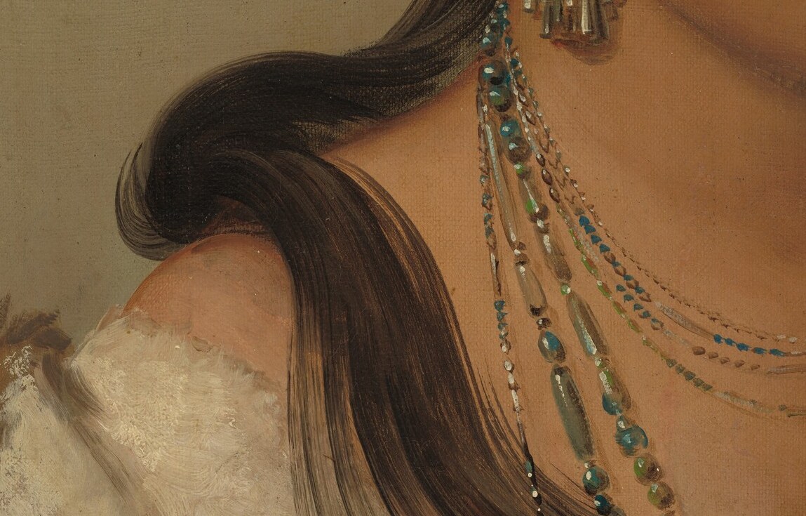Now, find the thin red line in her dark hair.