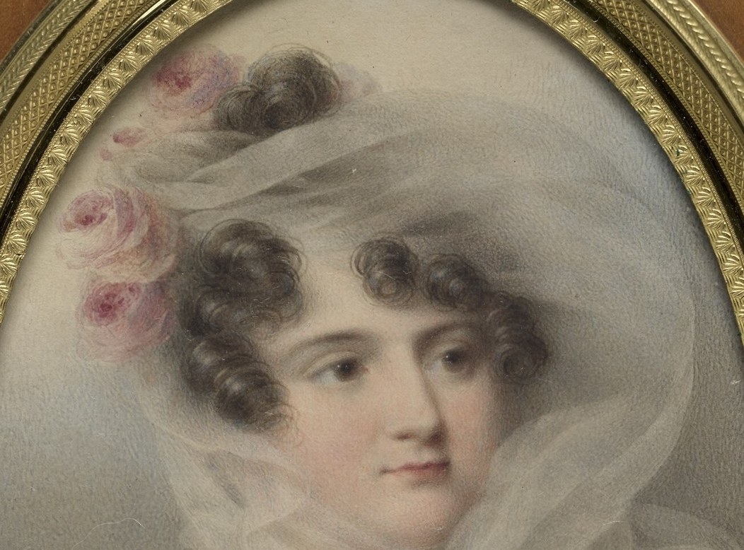 Notice her delicate veil and the soft pink roses.