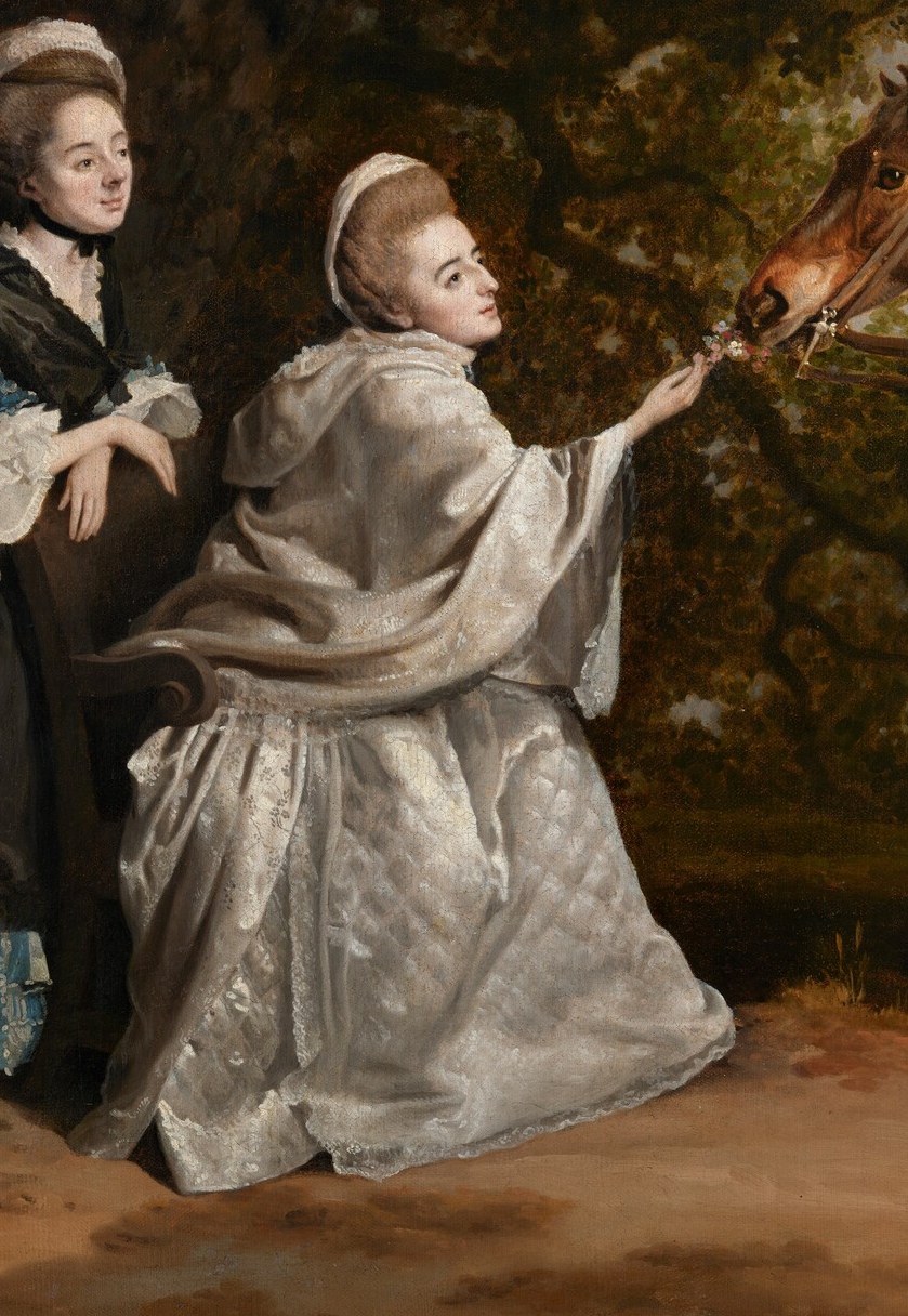Her gentle gesture towards the horse suggests a tender connection and grace.