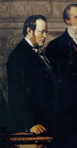 A stern-faced diplomat, his posture suggesting importance and perhaps reservation.