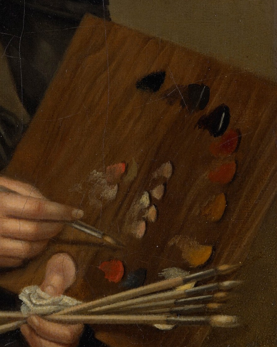 She holds an artist's palette and paint brushes.